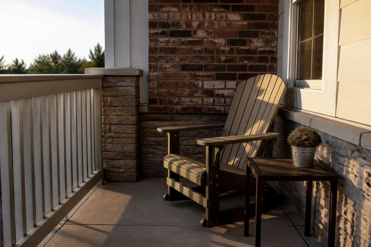 Compact porch corner with an adirondack chair and small square side table