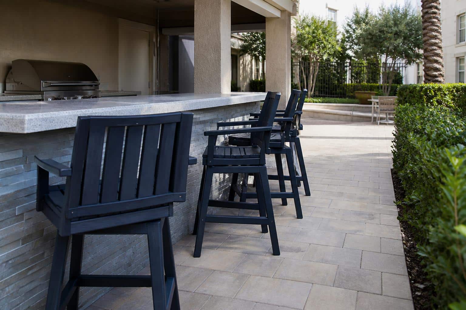 Marine Grade Polymer counter stools beside an outdoor bar