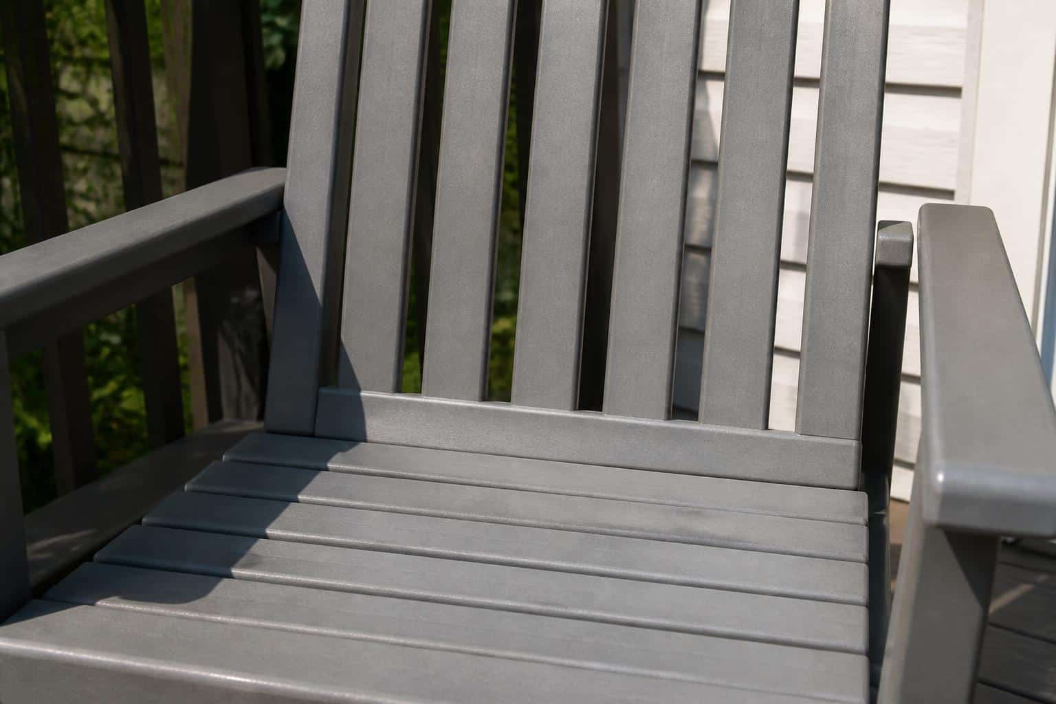 Close-up of an HDPE plastic chair seat and back slats showing smooth solid plastic texture with a slight matte sheen