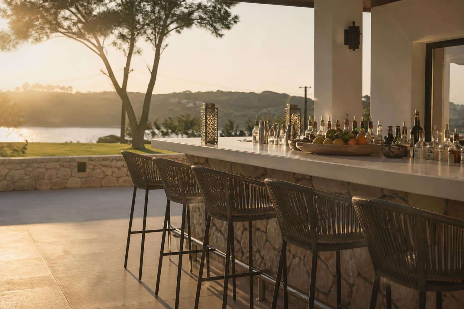 Outdoor bar counter with drinks and stools