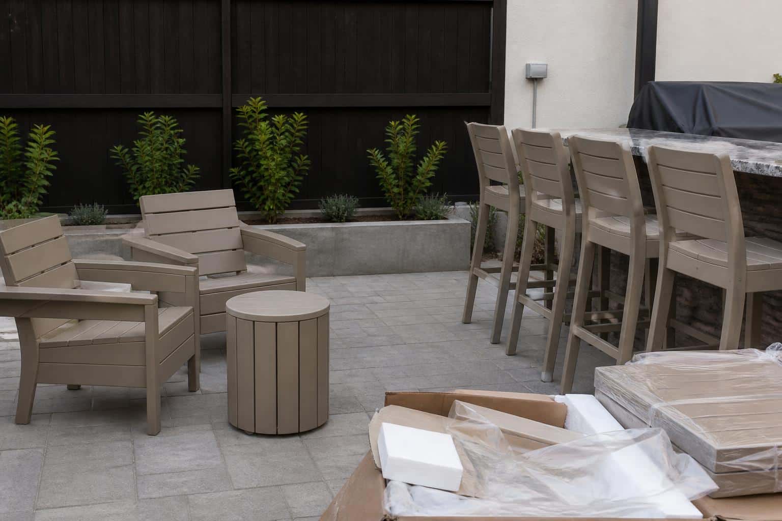 Patio stools beside saved packaging materials