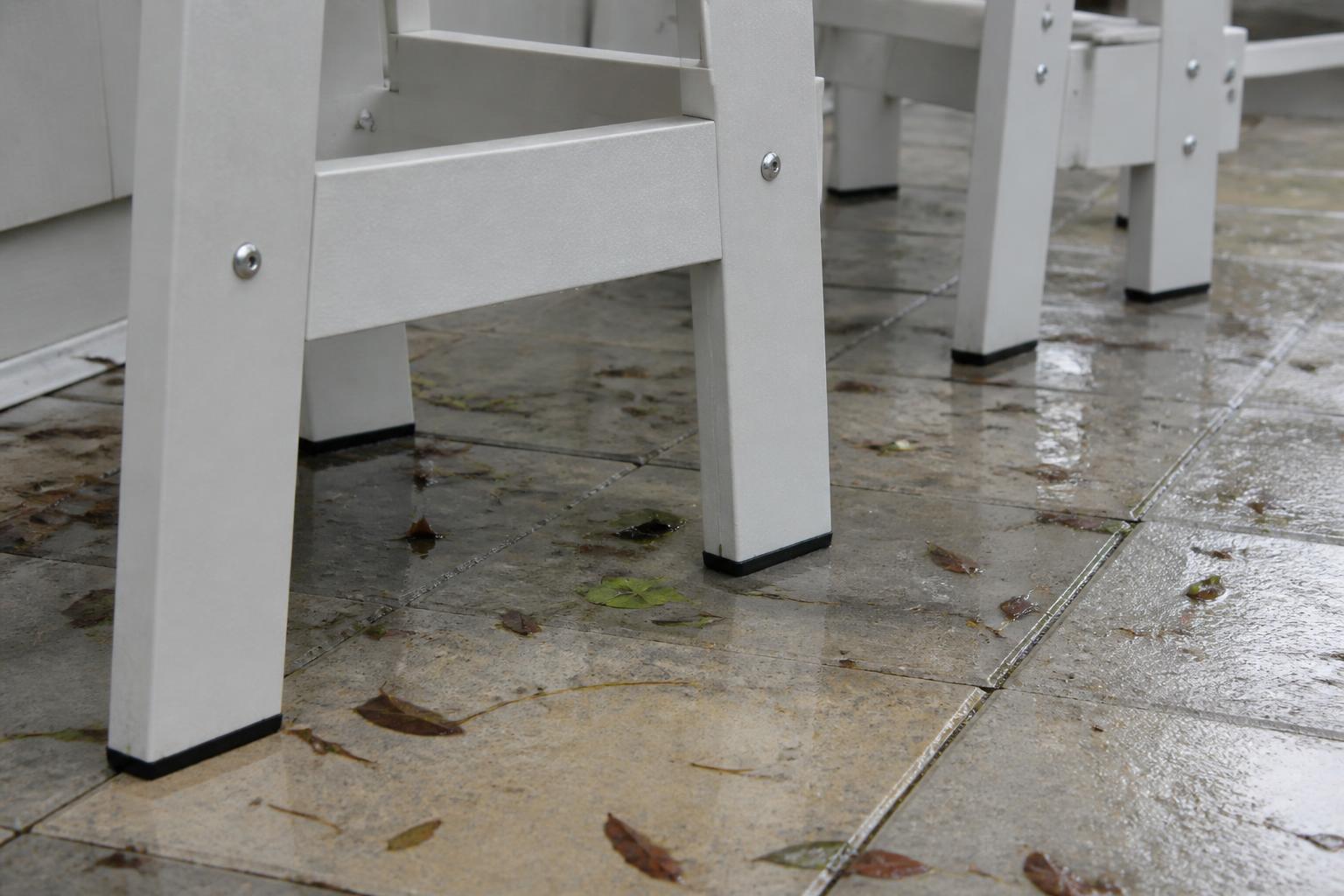 Marine Grade Polymer chair legs and stainless hardware on a rain-wet patio