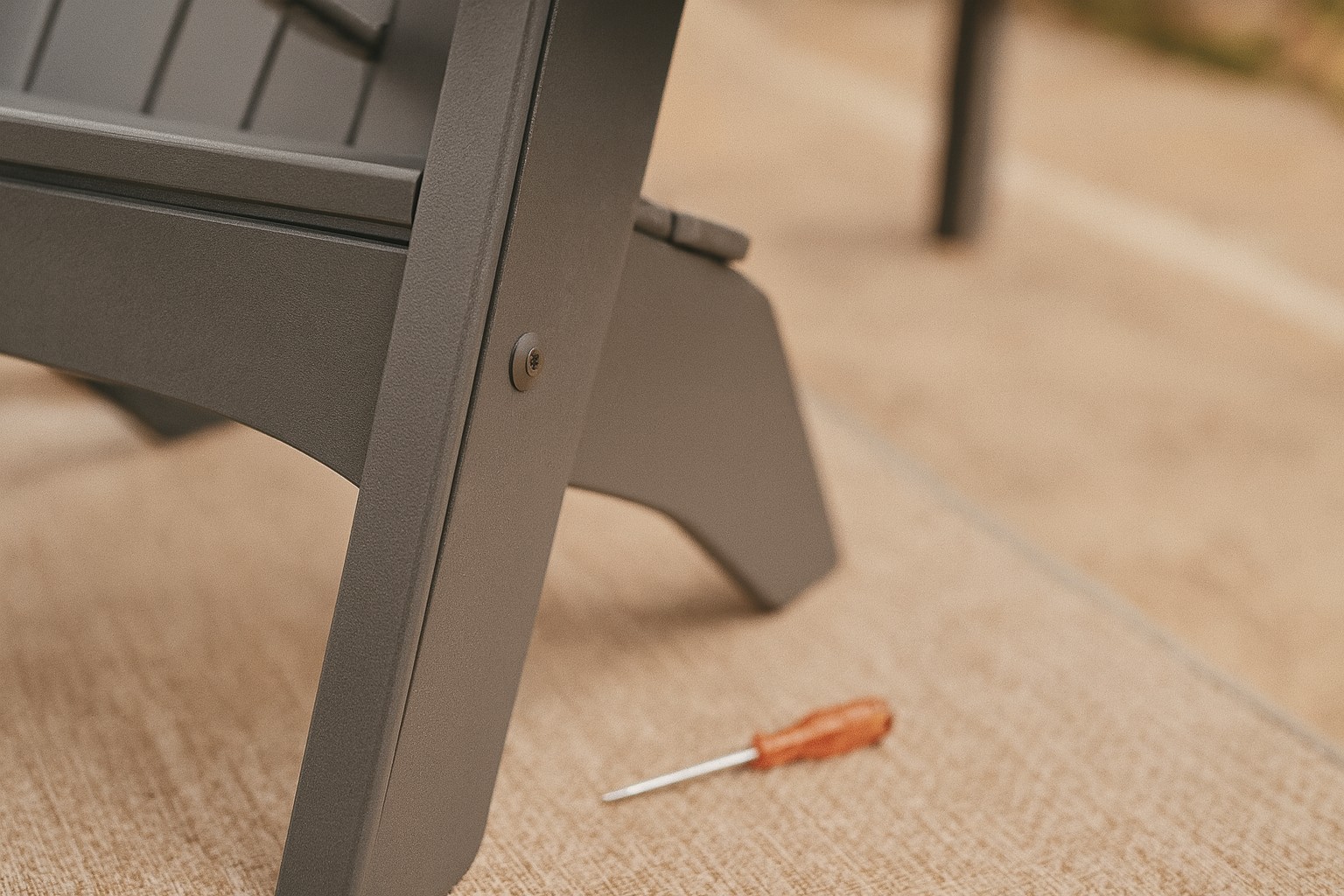 Close assembly check of a charcoal Hampton Adirondack Chair joint and base