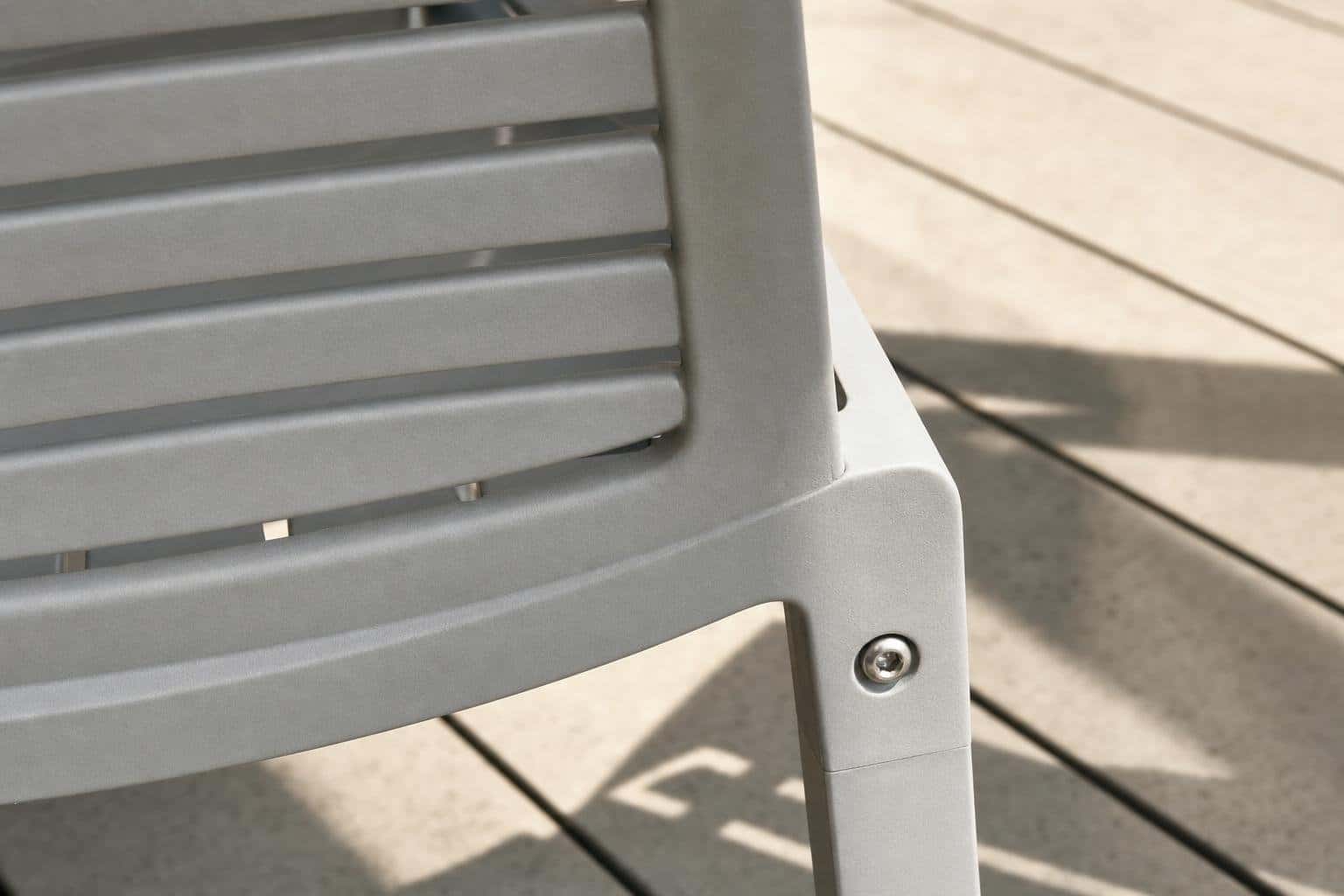 Smooth polymer chair edge with drainage gaps and a stainless fastener.