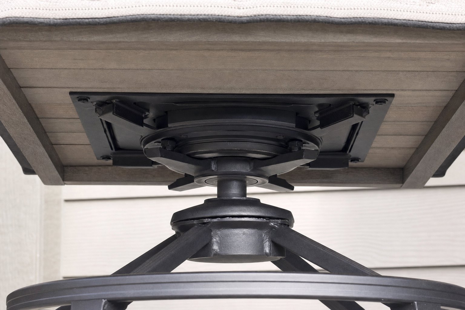 The unbranded rotating base beneath an outdoor counter stool.