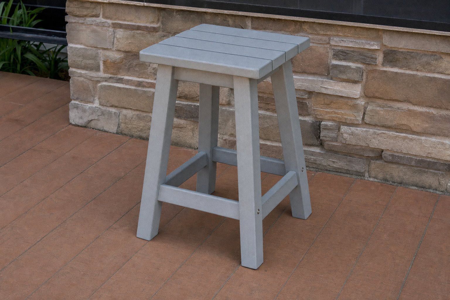 A stationary backless outdoor stool with fixed joints and stainless hardware.