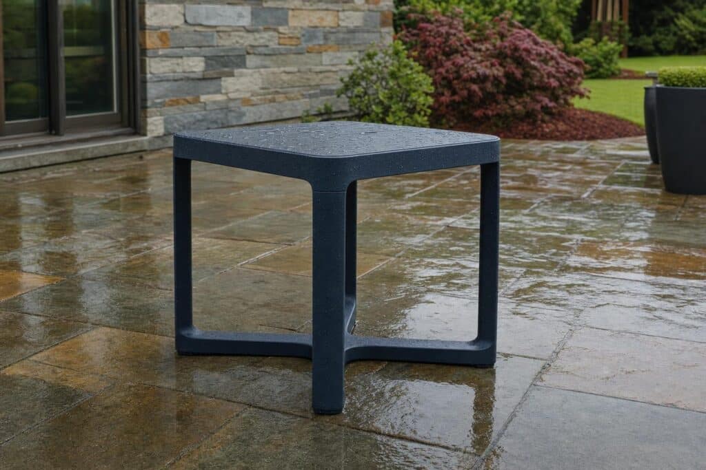 Rainwater beading on an unbranded polymer outdoor side table