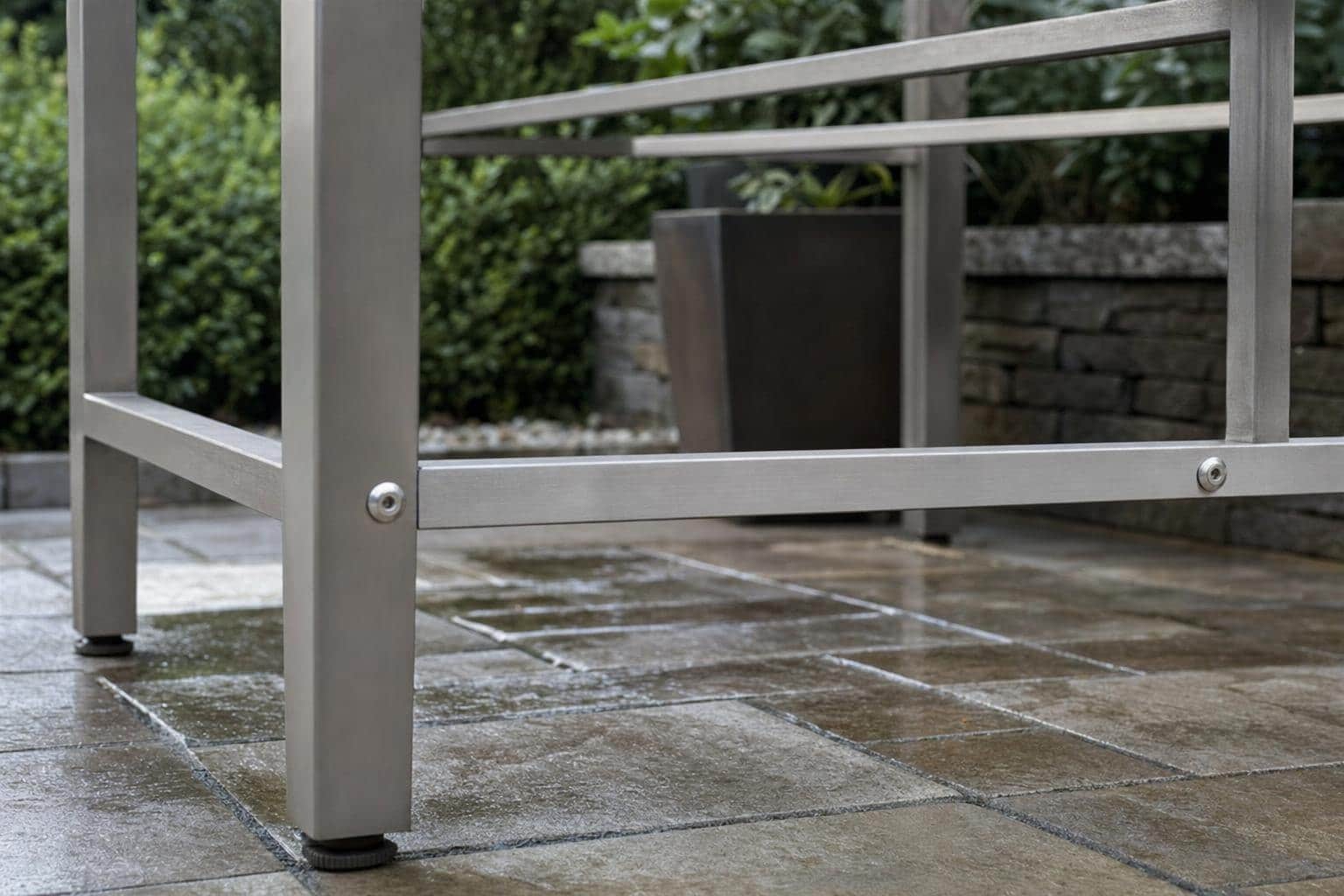 Stainless fasteners beneath an outdoor end table after rain
